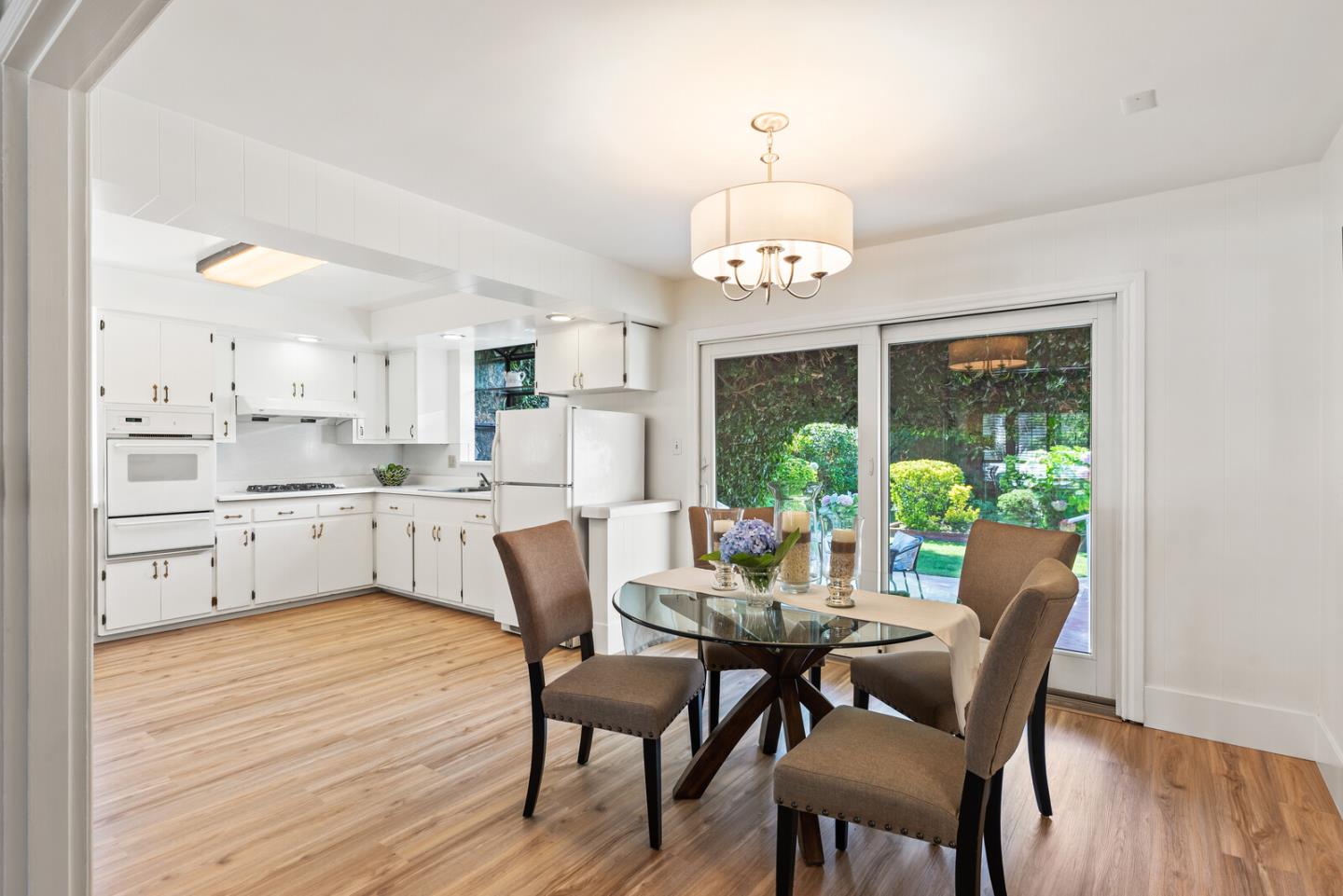 225 Victoria Road Burlingame, CA 94010 - Photo 8 of 29 a view of a dining room with furniture a chandelier and wooden floor