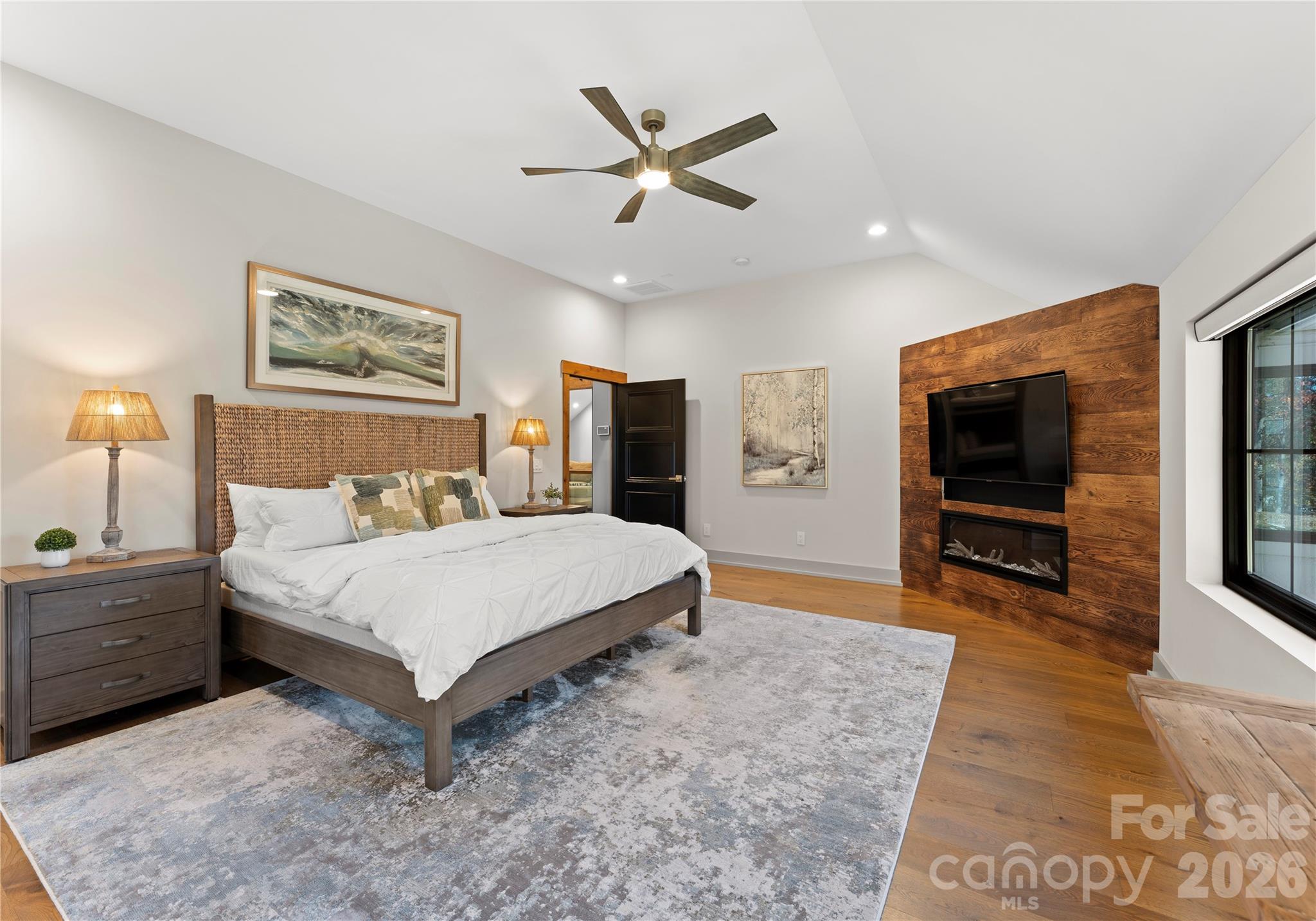 222 Greenbay Road Mooresville, NC 28117 - Photo 36 of 40 a bedroom with a large bed and a chandelier