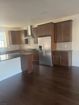 a kitchen with stainless steel appliances a microwave a stove and white cabinets