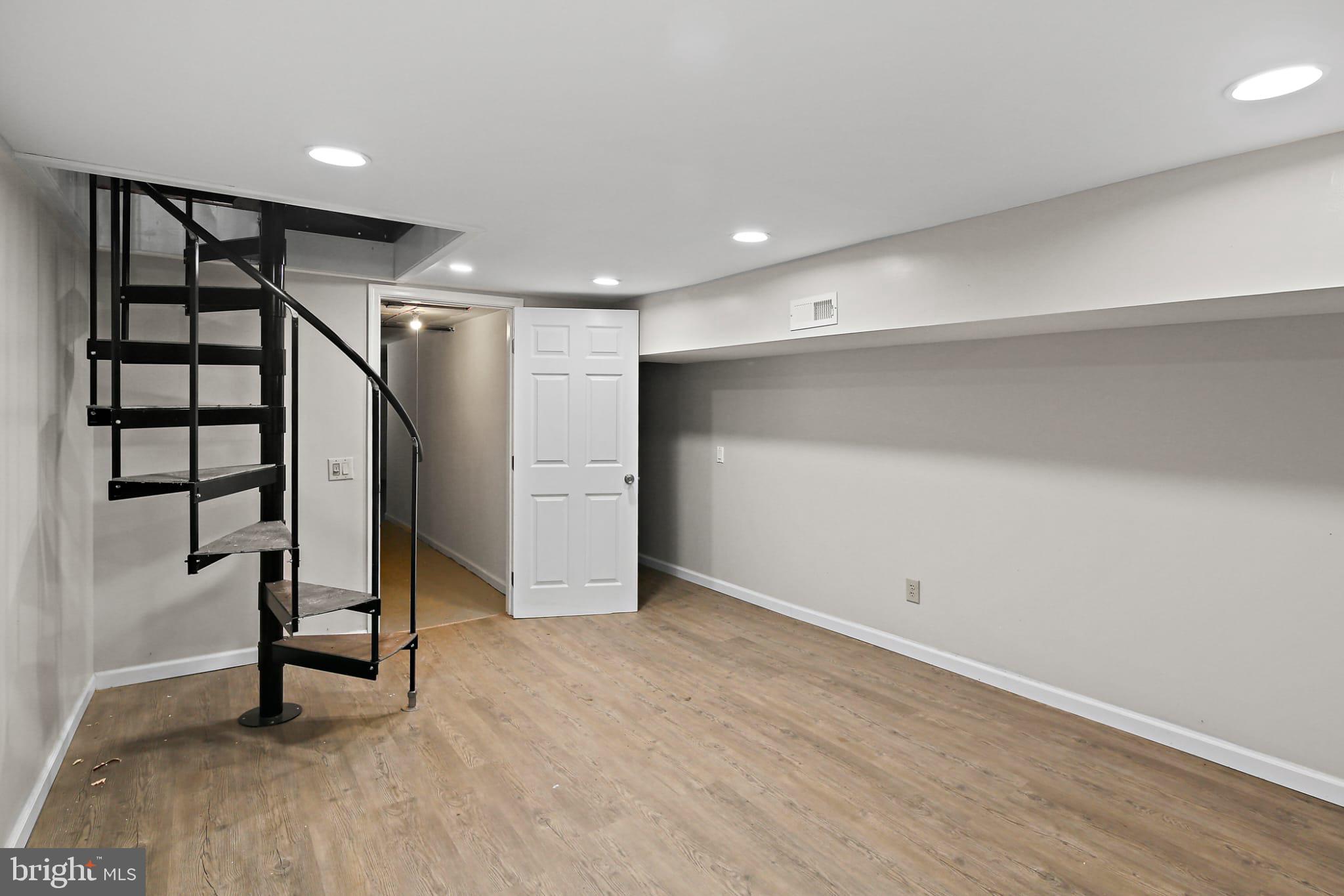 3924 Reisterstown Road Baltimore, MD 21215 - Photo 13 of 25 Versatile basement with spiral staircase charm.