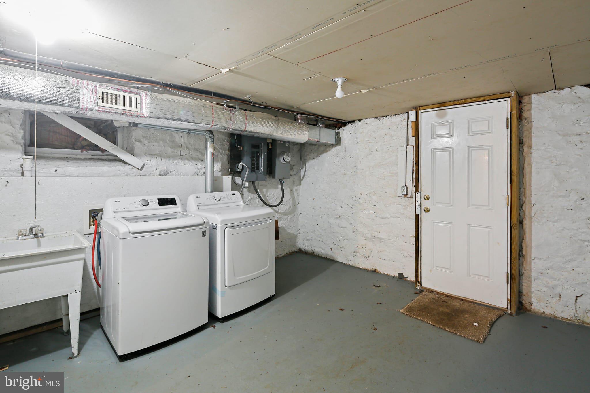 3924 Reisterstown Road Baltimore, MD 21215 - Photo 19 of 25 Functional basement laundry area with door access.
