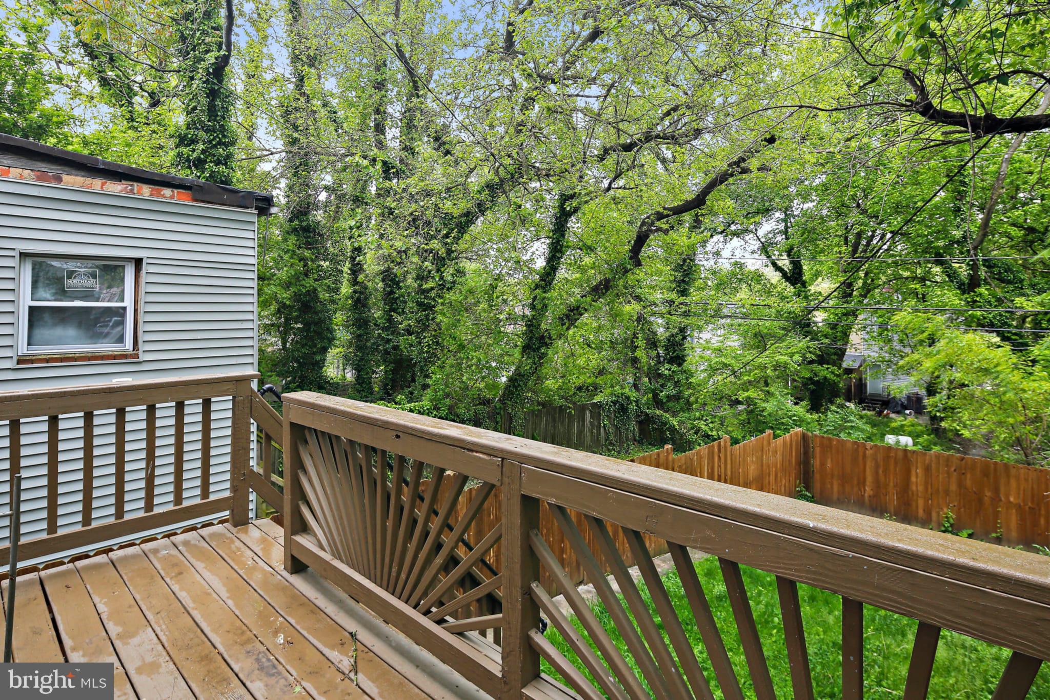 3924 Reisterstown Road Baltimore, MD 21215 - Photo 22 of 25 Serene deck overlooking lush greenery.
