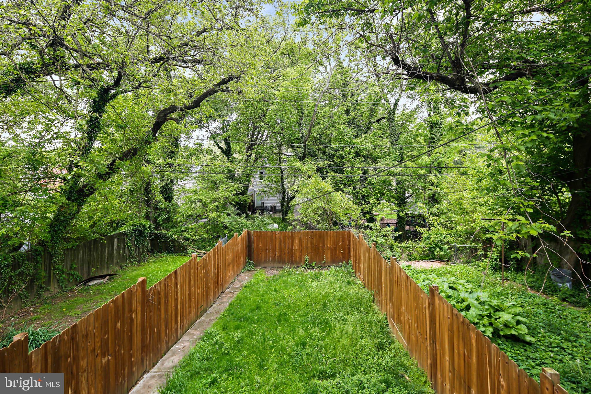 3924 Reisterstown Road Baltimore, MD 21215 - Photo 25 of 25 Lush green oasis with rustic wooden fence.