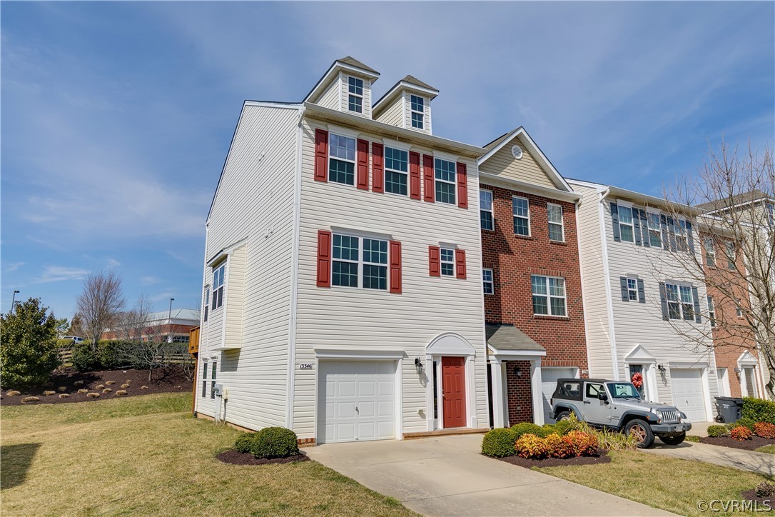 a front view of a residential apartment building with a yard