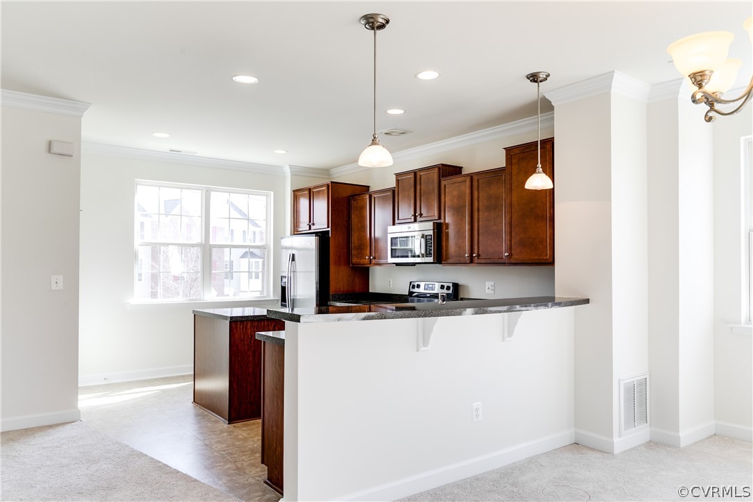 13346 Diamond Ridge Drive Midlothian, VA 23112 - Photo 16 of 42 a kitchen with stainless steel appliances granite countertop a sink window and cabinets