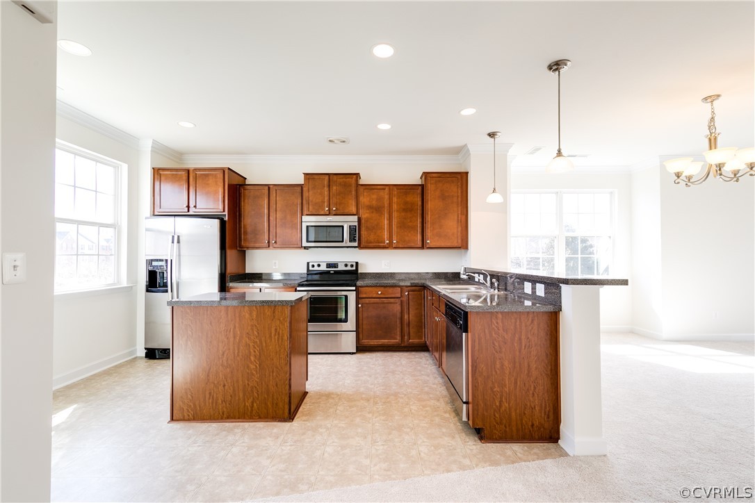 13346 Diamond Ridge Drive Midlothian, VA 23112 - Photo 18 of 42 a large kitchen with stainless steel appliances granite countertop a stove a refrigerator a sink dishwasher a oven and a dining table with wooden floor