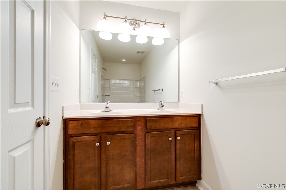 13346 Diamond Ridge Drive Midlothian, VA 23112 - Photo 29 of 42 a bathroom with a double vanity sink and a mirror