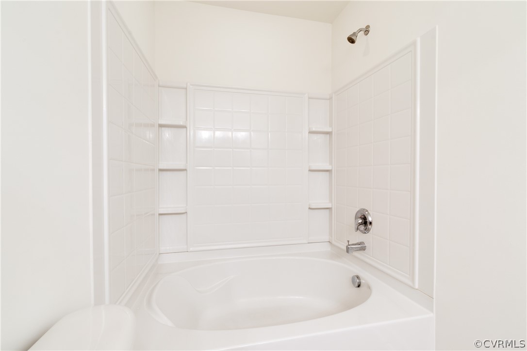 13346 Diamond Ridge Drive Midlothian, VA 23112 - Photo 30 of 42 a white bath tub sitting next to a white sink and vanity