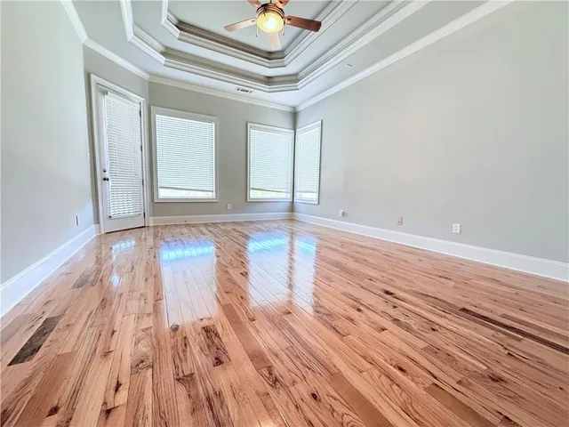 a view of an empty room and wooden floor