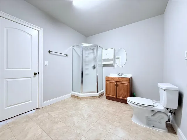 a bathroom with a toilet sink and shower