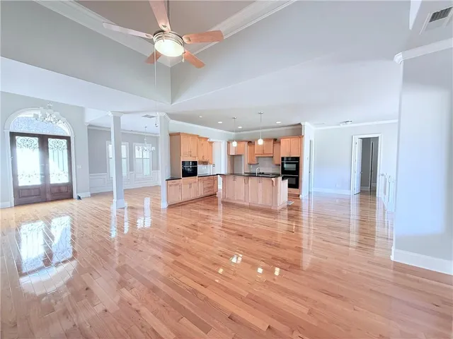 a view interior of a house with wooden floor and a kitchen