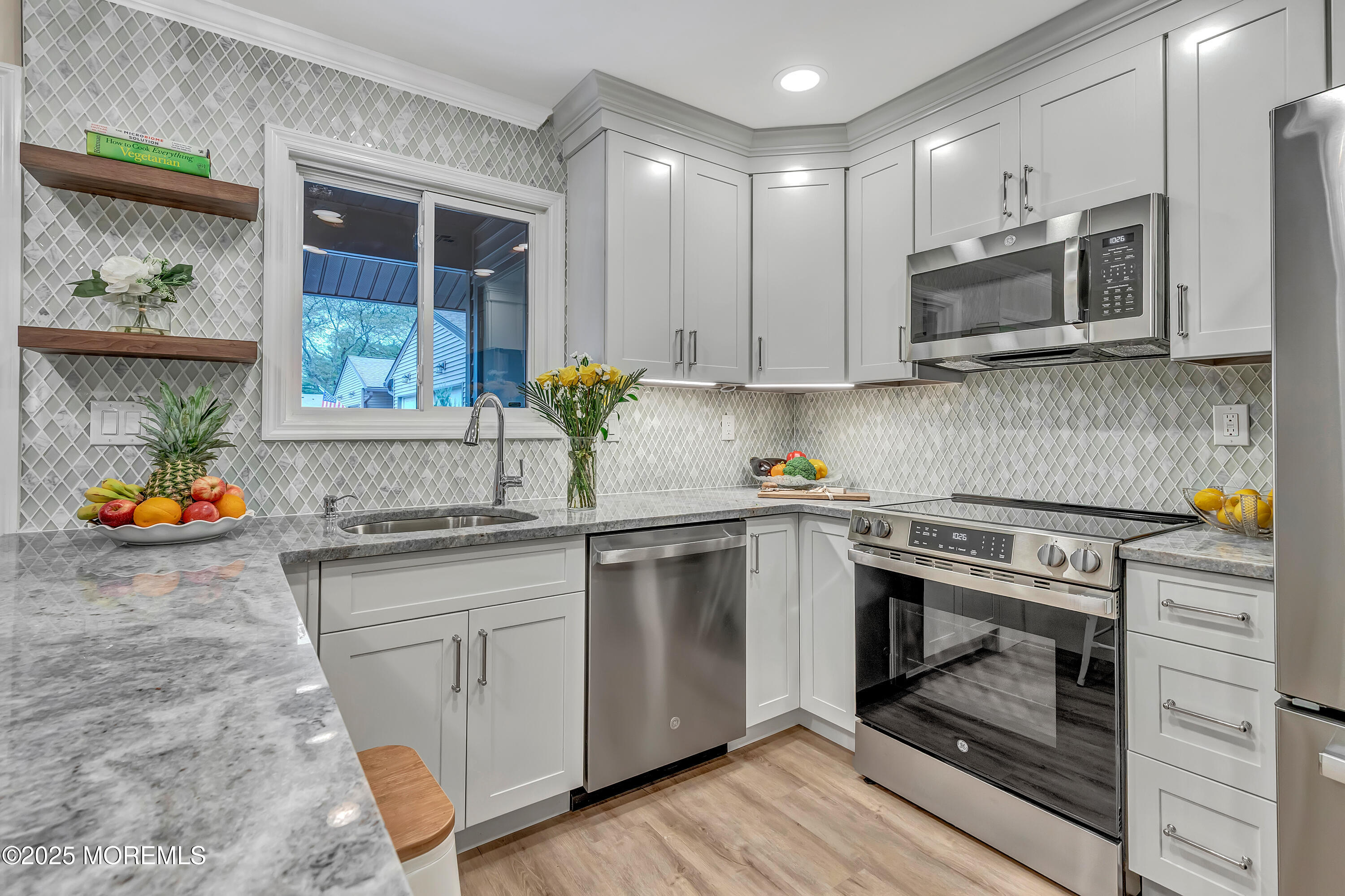 10 Ellsworth Court Red Bank, NJ 07701 - Photo 12 of 40 a kitchen with stainless steel appliances granite countertop a stove a sink and a microwave