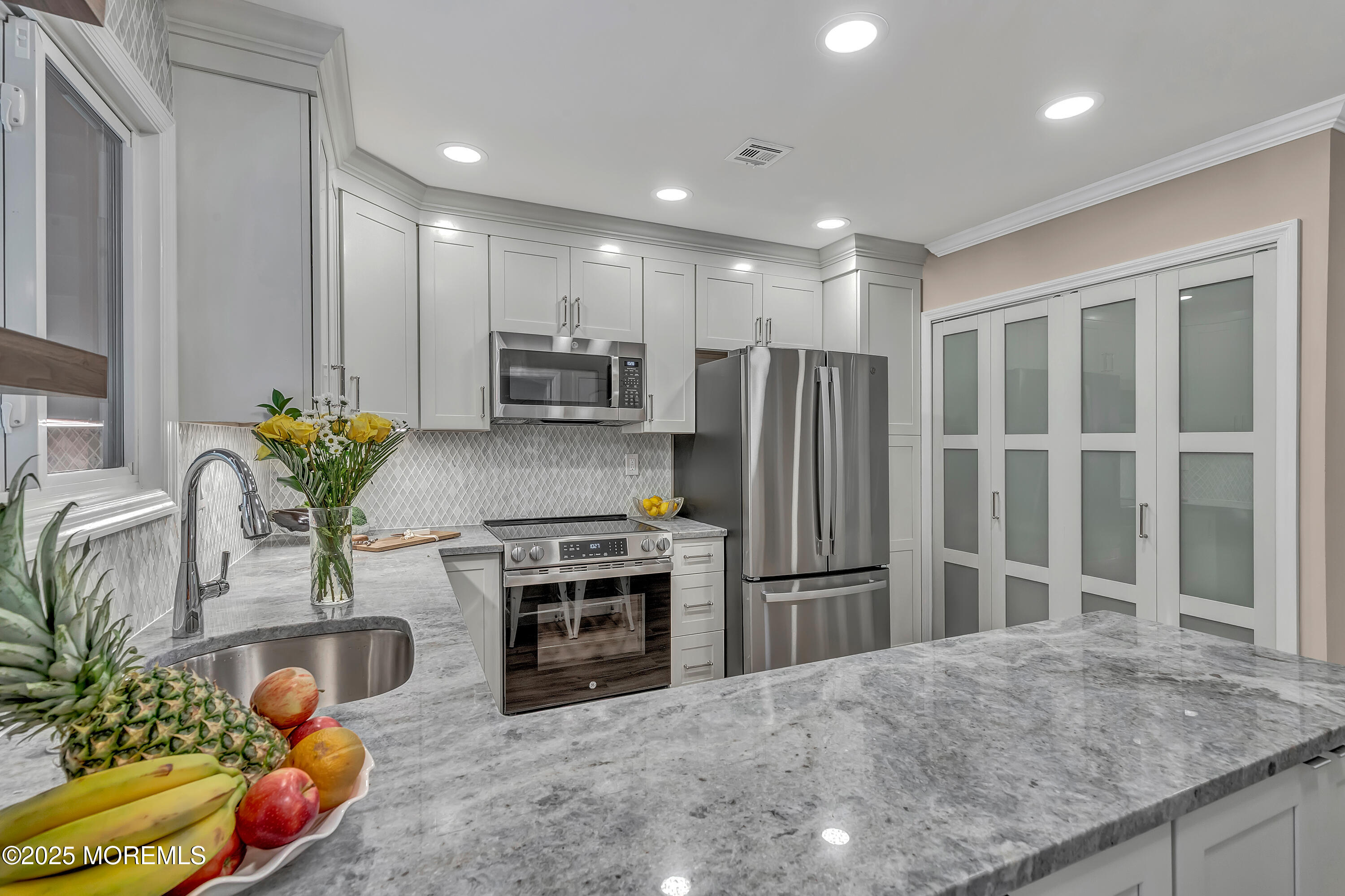10 Ellsworth Court Red Bank, NJ 07701 - Photo 13 of 40 a kitchen with stainless steel appliances a refrigerator sink and cabinets