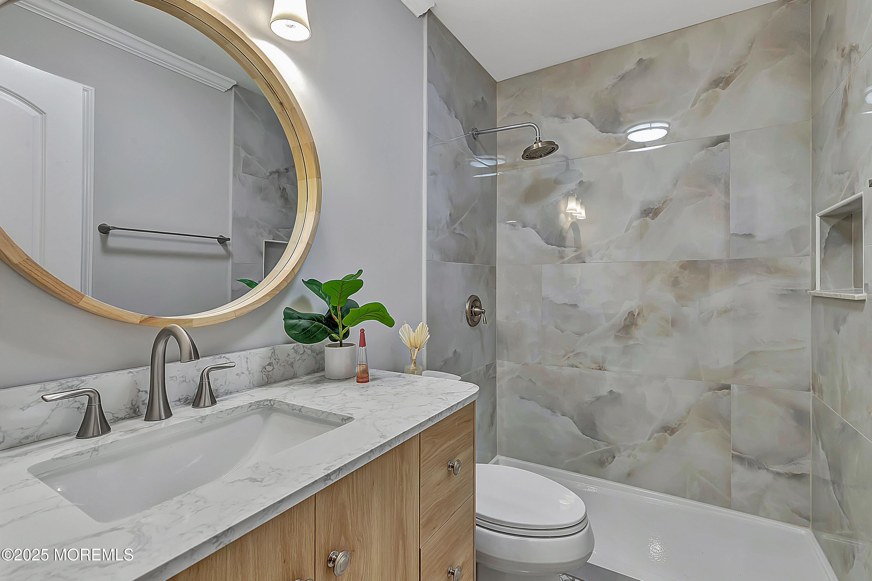 10 Ellsworth Court Red Bank, NJ 07701 - Photo 24 of 40 a bathroom with a granite countertop sink a toilet a mirror and shower