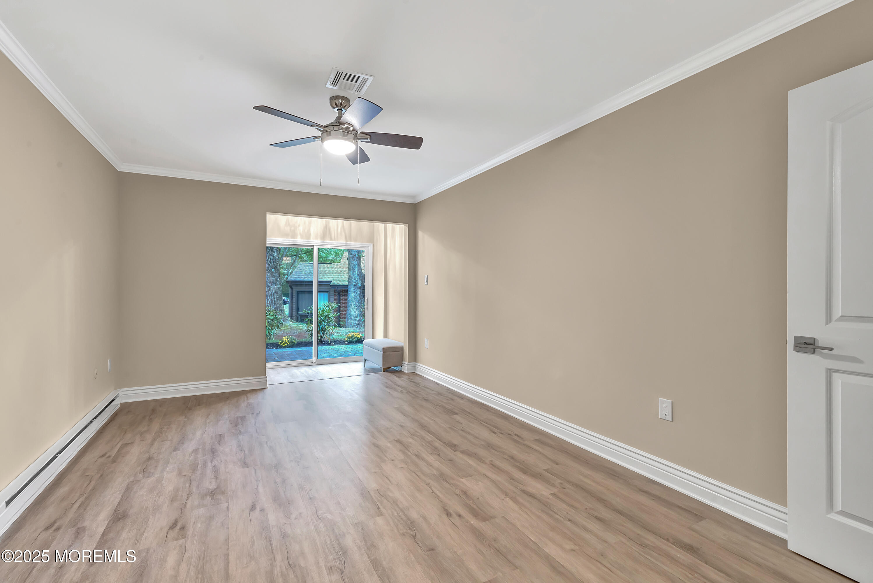 10 Ellsworth Court Red Bank, NJ 07701 - Photo 26 of 40 a view of an empty room with wooden floor and a window