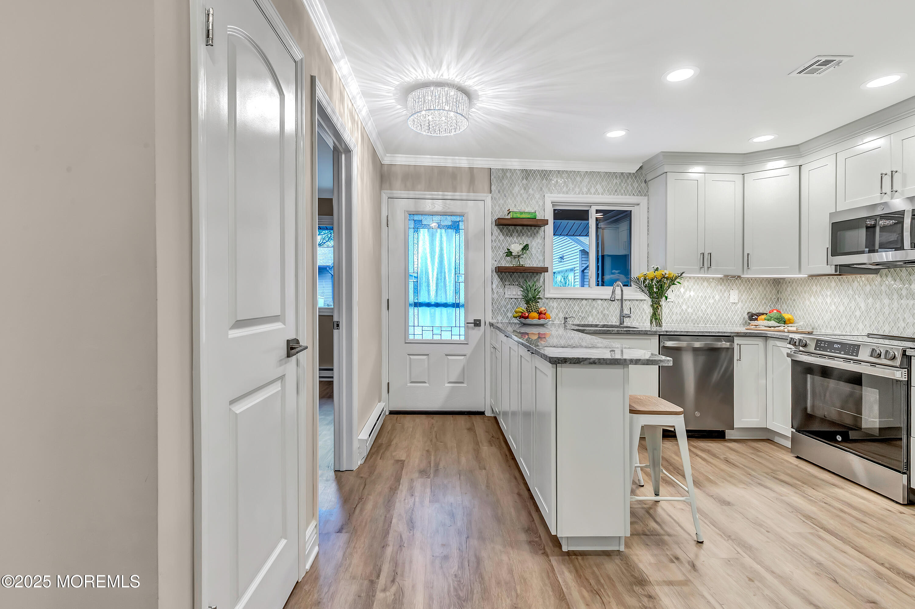10 Ellsworth Court Red Bank, NJ 07701 - Photo 6 of 40 a kitchen with kitchen island granite countertop a sink cabinets and stainless steel appliances