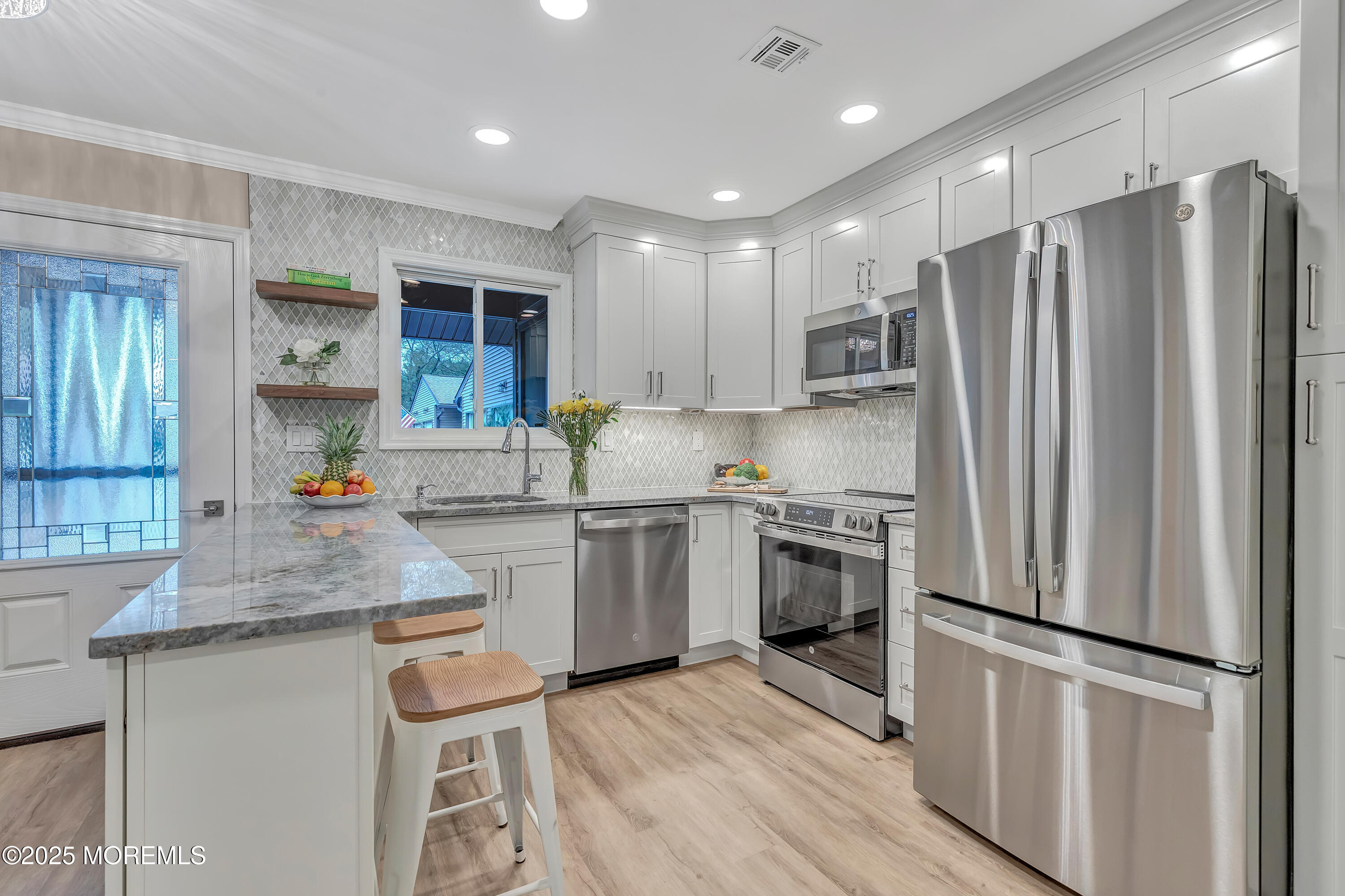 10 Ellsworth Court Red Bank, NJ 07701 - Photo 9 of 40 a kitchen with stainless steel appliances granite countertop a refrigerator sink and stove