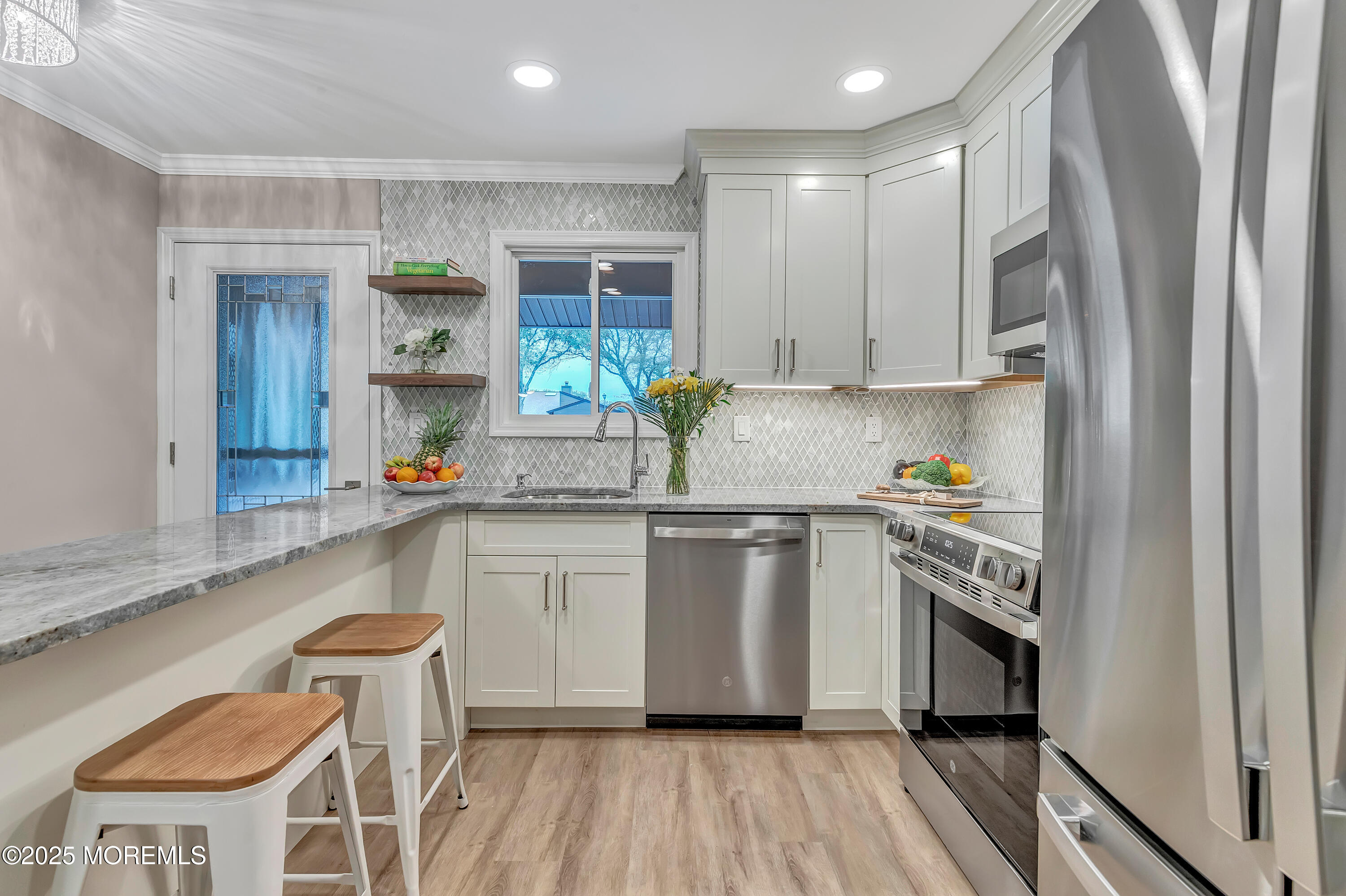 10 Ellsworth Court Red Bank, NJ 07701 - Photo 10 of 40 a kitchen with stainless steel appliances granite countertop a stove a sink and a refrigerator