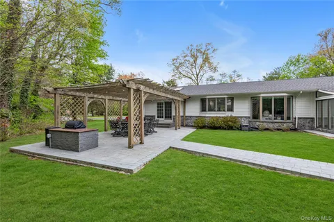 a view of a house with a yard and sitting area