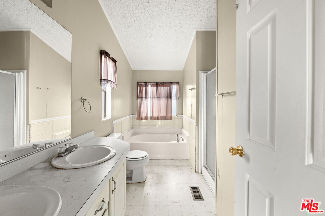 6425 Smoke Tree Road Phelan, CA 92371 - Photo 13 of 35 a bathroom with a sink double vanity granite tub and shower