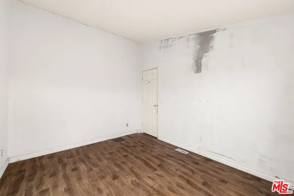 a view of a room with wooden floor