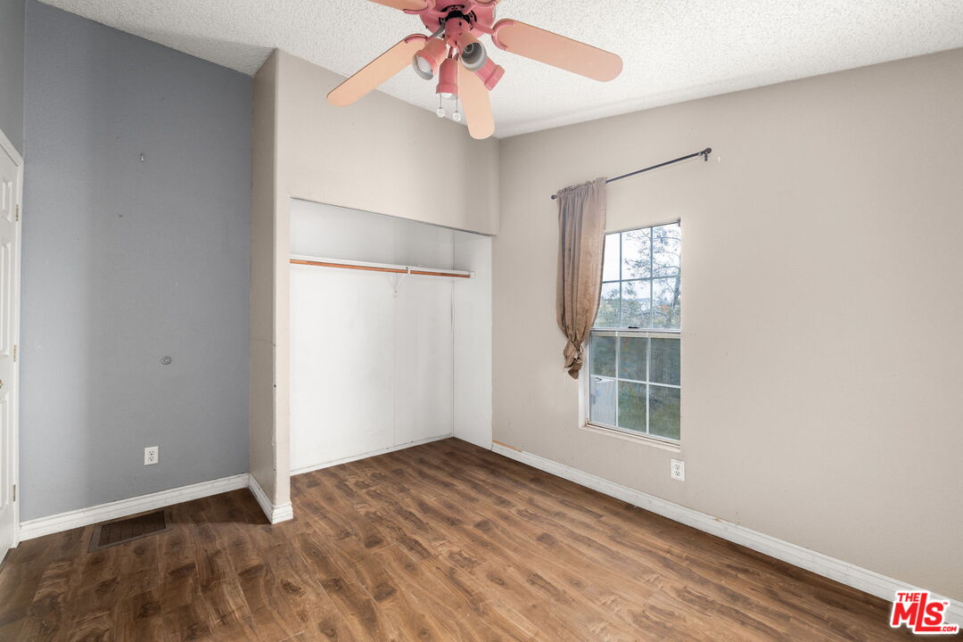 6425 Smoke Tree Road Phelan, CA 92371 - Photo 17 of 35 wooden floor in an empty room with a window