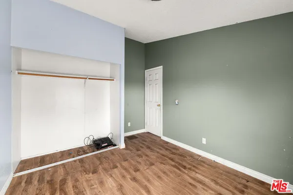 a view of a room with wooden floor