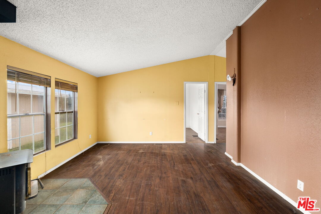 6425 Smoke Tree Road Phelan, CA 92371 - Photo 7 of 35 a view of an empty room with wooden floor and a window