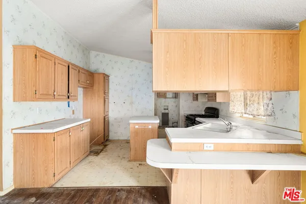 a large bathroom with a granite countertop sink a bathtub and window