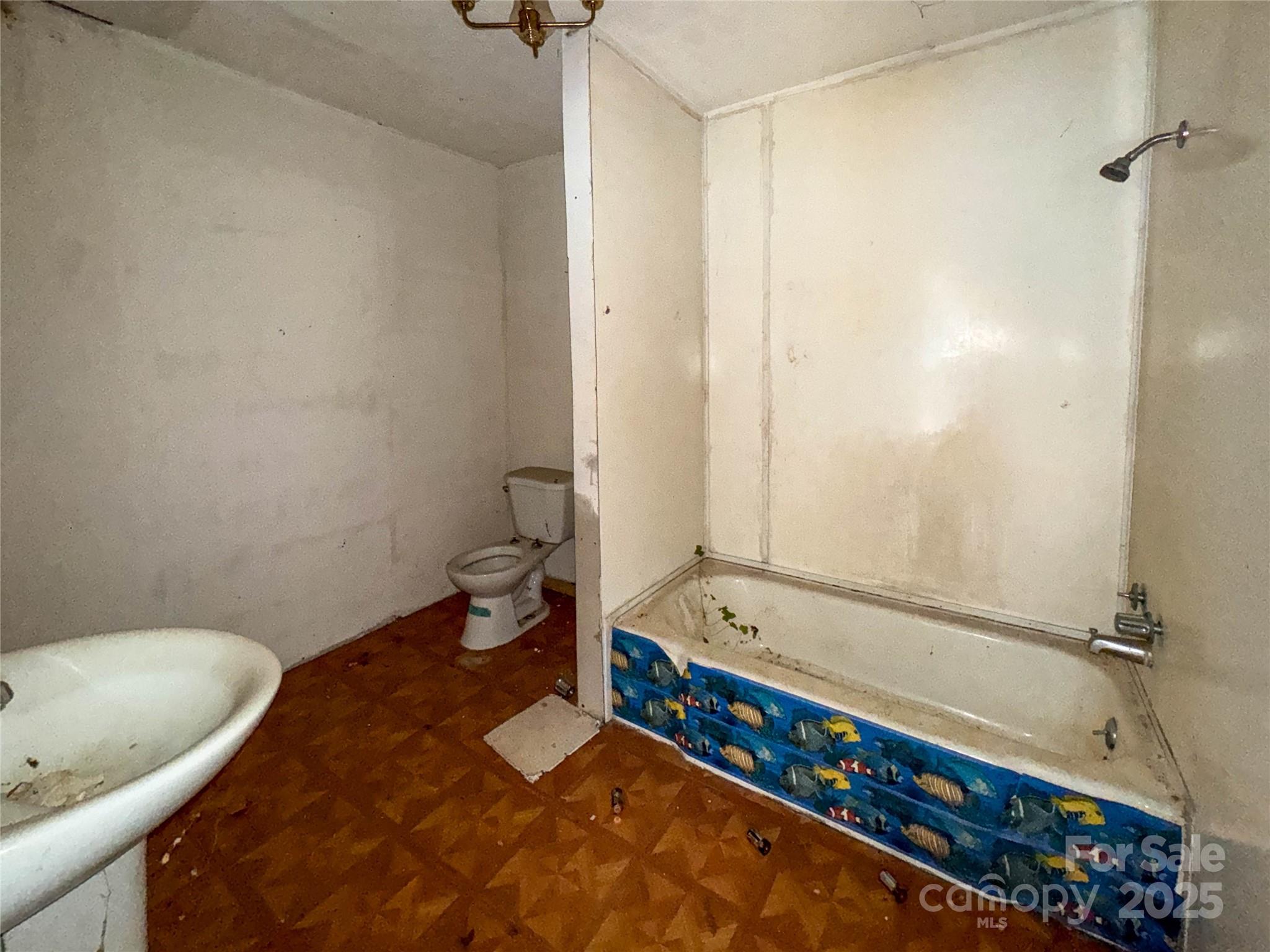 218 Cub Creek Road Bakersville, NC 28705 - Photo 17 of 20 a bathroom with a tub a toilet and a shower