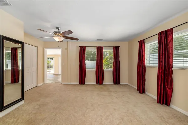 a view of a livingroom with a ceiling fan and entryway