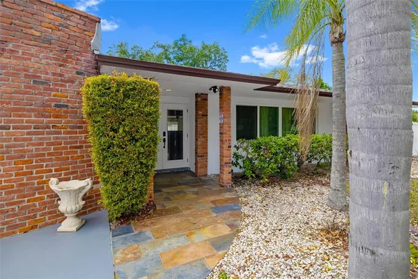 a kitchen with stainless steel appliances granite countertop a sink a refrigerator and a refrigerator