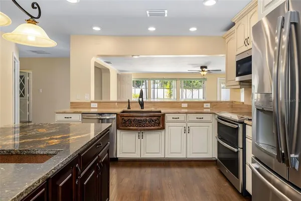 a kitchen with stainless steel appliances granite countertop a stove and a microwave