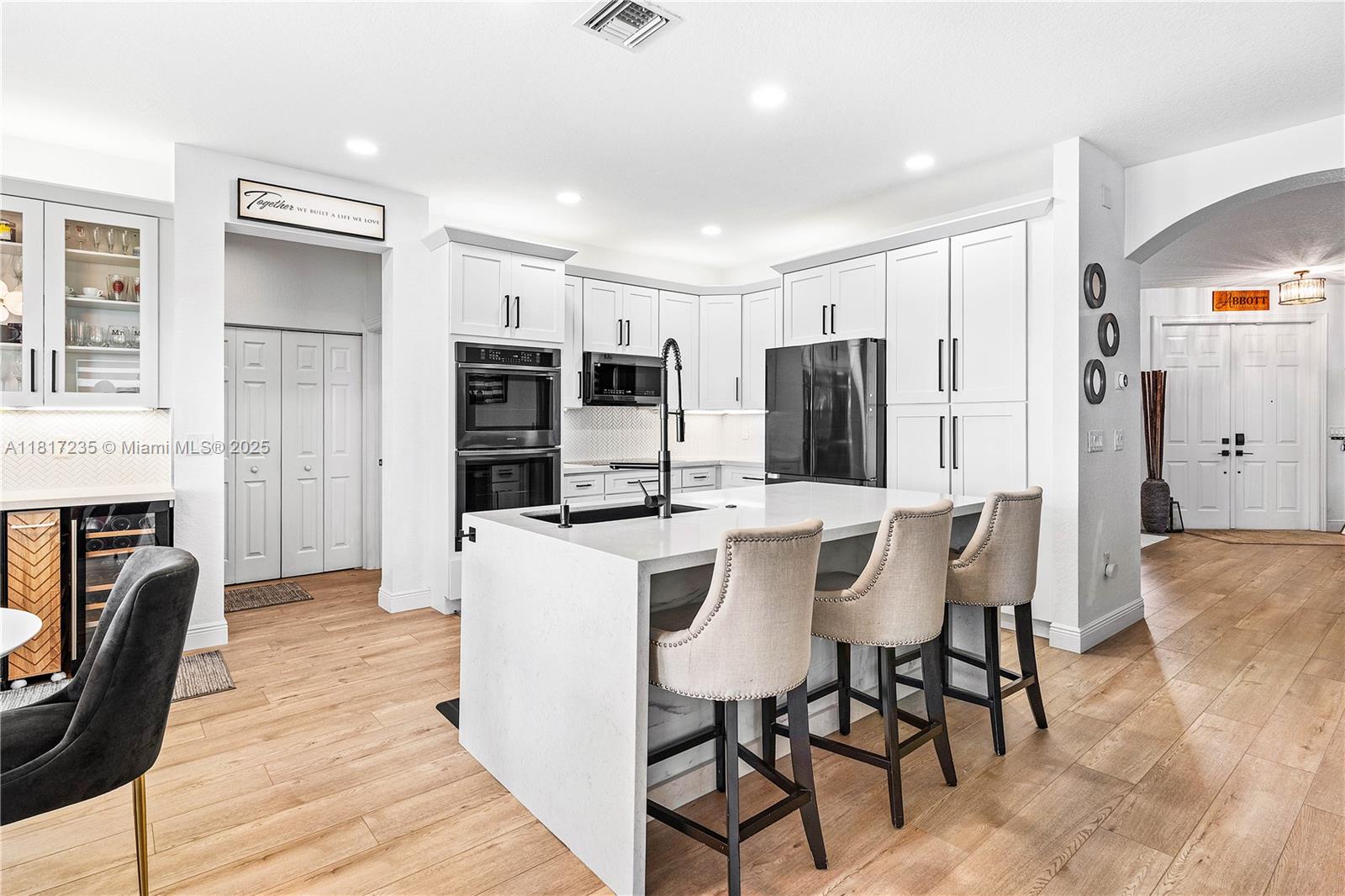 4356 Southwest 179th Way Miramar, FL 33029 - Photo 18 of 65 a kitchen with stainless steel appliances a dining table chairs microwave and refrigerator