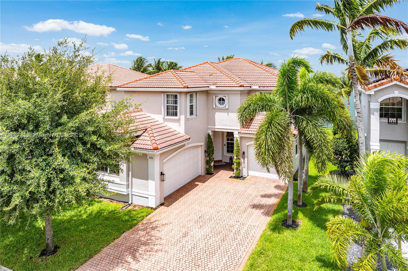 4356 Southwest 179th Way Miramar, FL 33029 - Photo 2 of 65 a view of a white house with a yard and potted plants