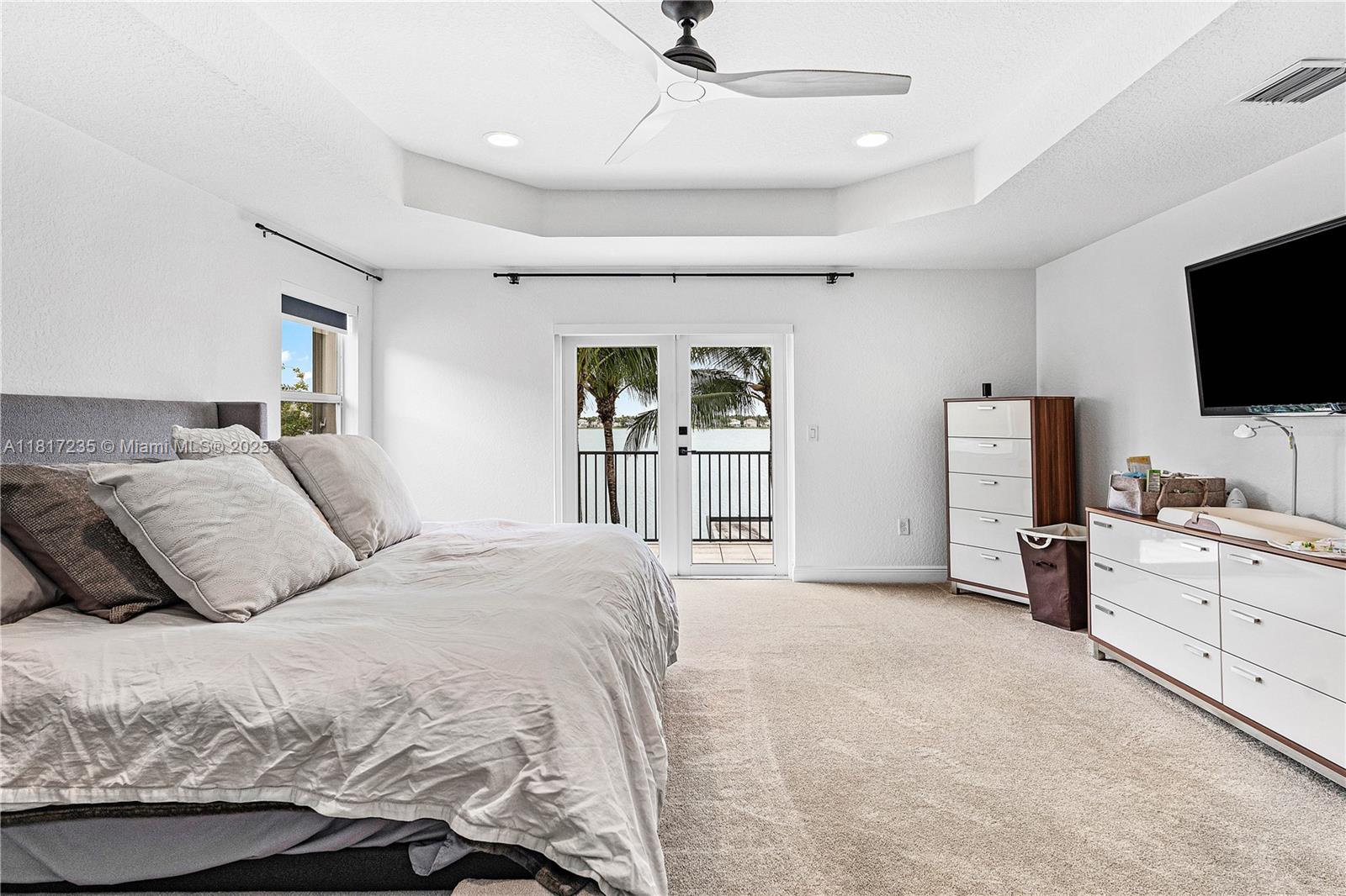 4356 Southwest 179th Way Miramar, FL 33029 - Photo 25 of 65 a bedroom with a large bed and a flat screen tv