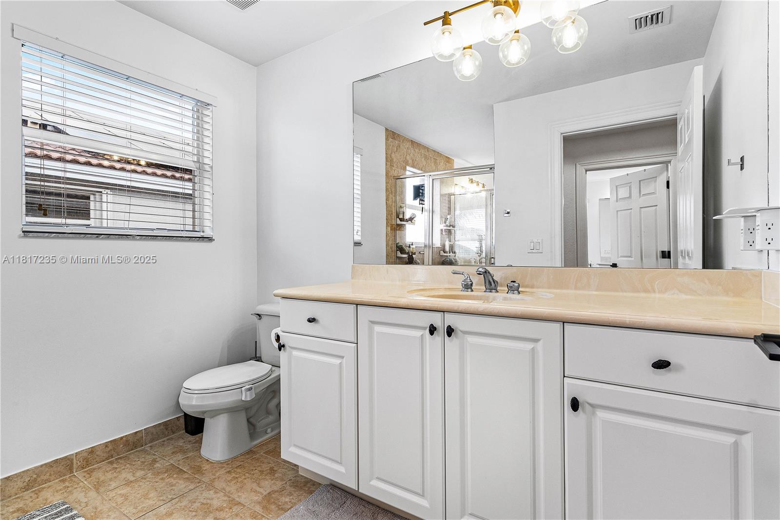 4356 Southwest 179th Way Miramar, FL 33029 - Photo 28 of 65 a bathroom with a granite countertop sink a toilet and a mirror