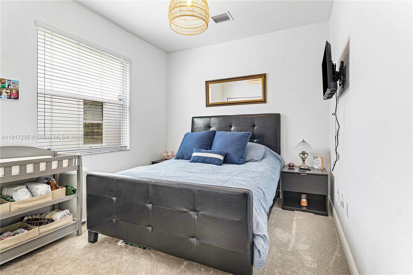 4356 Southwest 179th Way Miramar, FL 33029 - Photo 37 of 65 a bedroom with a bed and a window