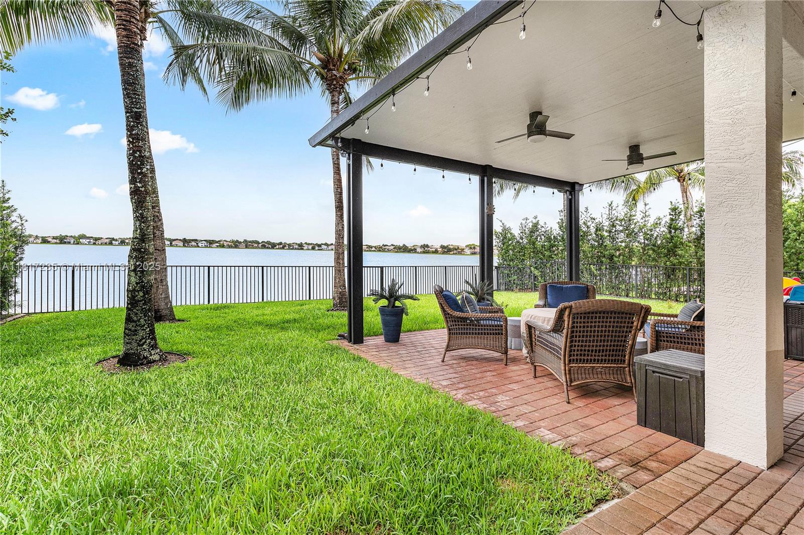 4356 Southwest 179th Way Miramar, FL 33029 - Photo 39 of 65 a view of a patio with table and chairs next to a yard