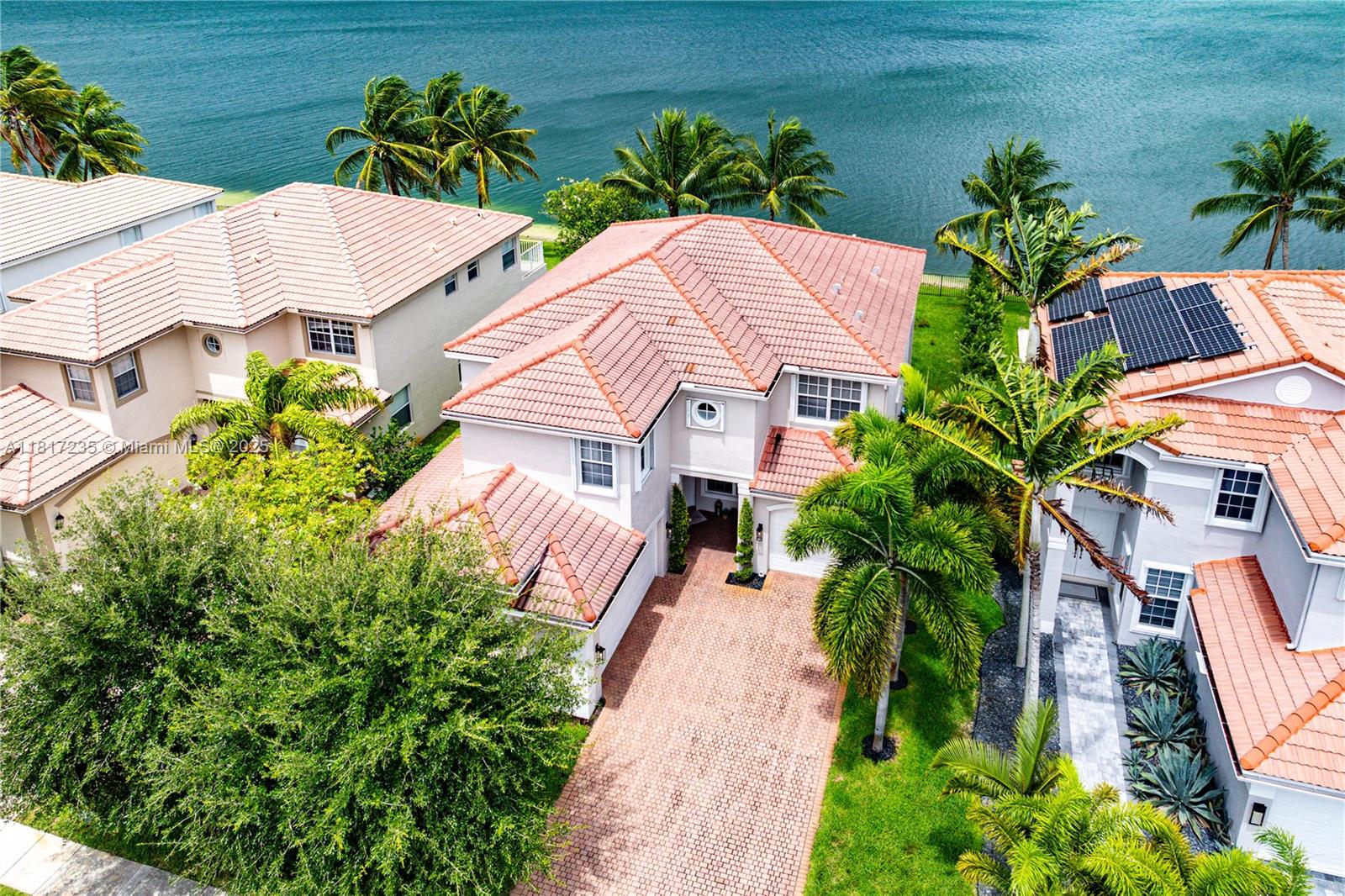 4356 Southwest 179th Way Miramar, FL 33029 - Photo 47 of 65 a view of a white house with a yard and garden