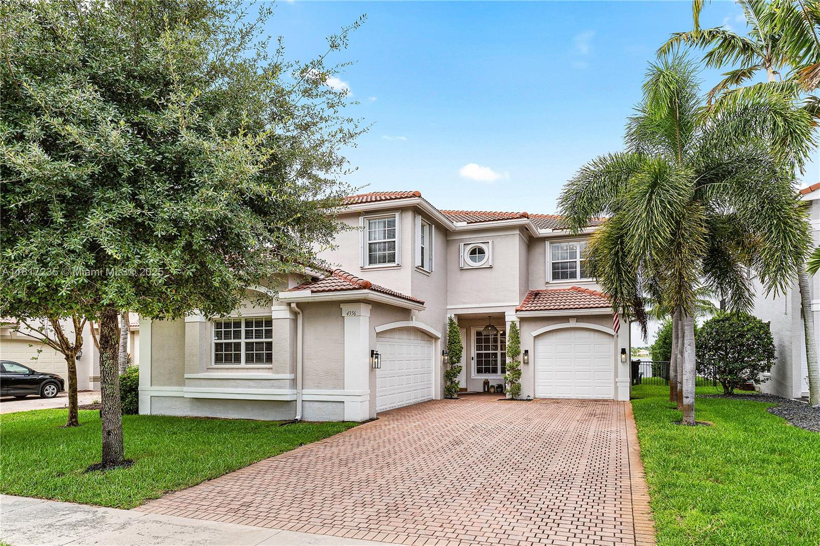 4356 Southwest 179th Way Miramar, FL 33029 - Photo 8 of 65 a front view of a house with a garden and trees