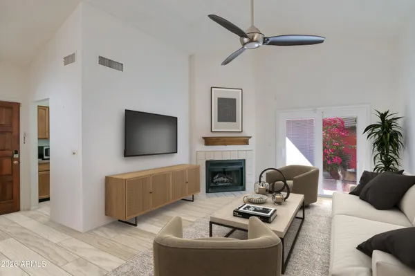 a living room with furniture a fireplace and a flat screen tv