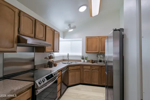 a kitchen with a sink stove and cabinets