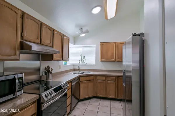 a kitchen with a sink appliances and cabinets