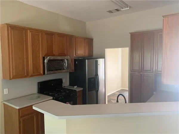 a kitchen with stainless steel appliances granite countertop a refrigerator stove a sink and dishwasher