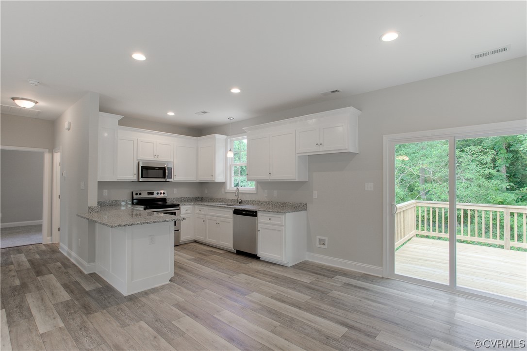 3503 Sylvania Road Chester, VA 23831 - Photo 9 of 26 a kitchen with a sink wooden floor and stainless steel appliances