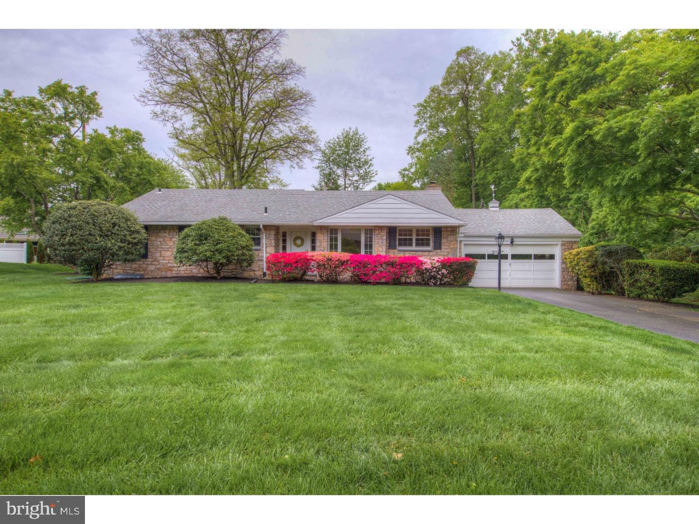 a view of a house with a big yard and large trees