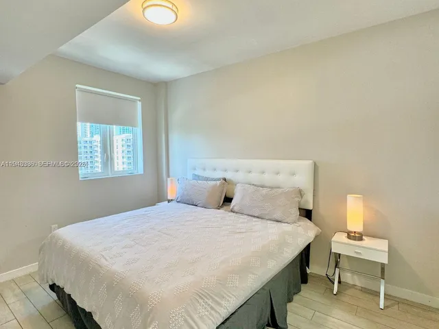 a bedroom with a bed and a lamp