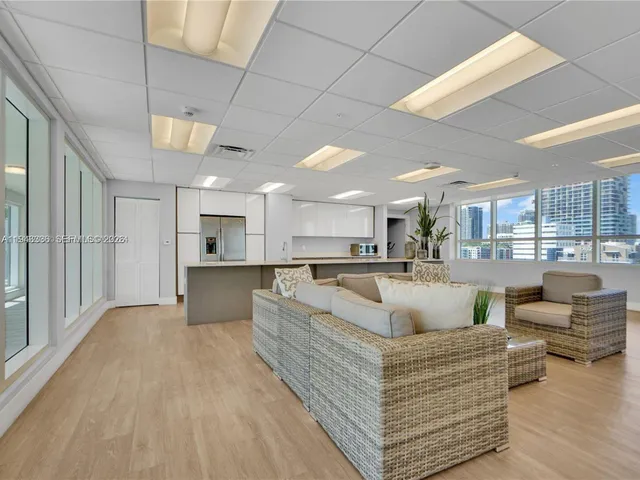 a living room with furniture and kitchen view