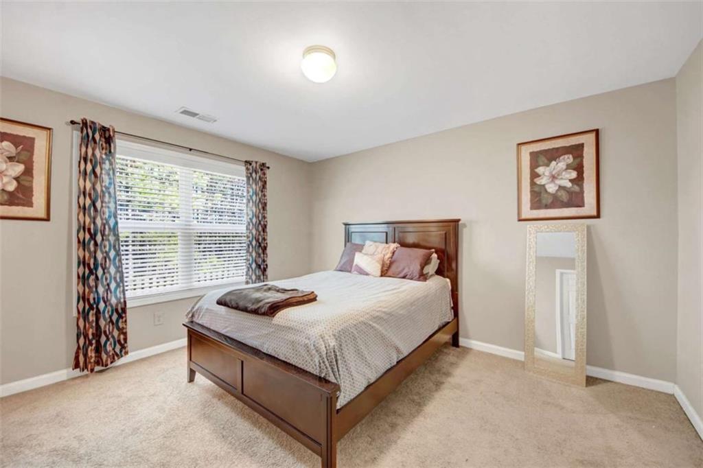 2555 Flat Shoals Road South Fulton, GA 30349 - Photo 14 of 20 a bedroom with a bed and a window